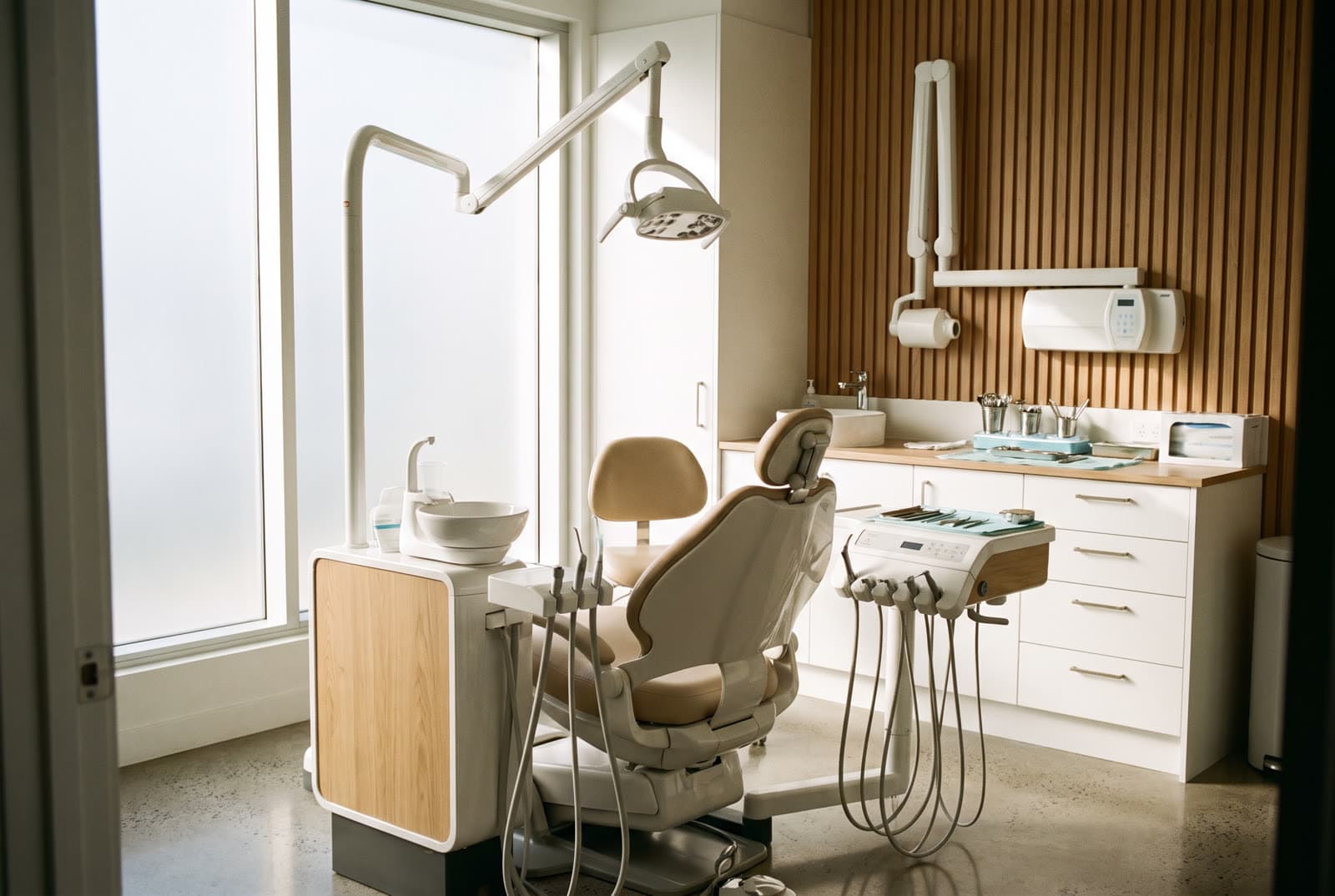 Modern dental operatory with an empty patient chair in morning light
